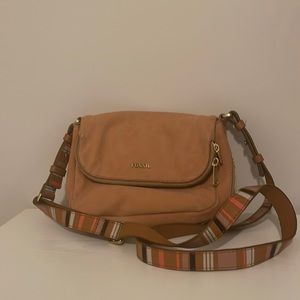 Pink Fossil crossbody bag/purse with flap and striped strap.